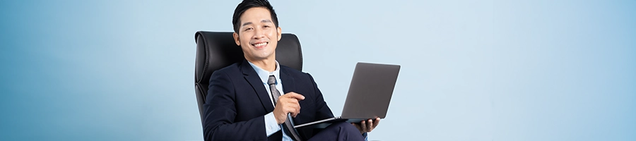 Registered agent sitting while using laptop