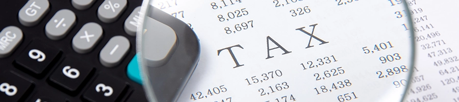 Magnifying glass showing TAX deductible for a Florida LLC