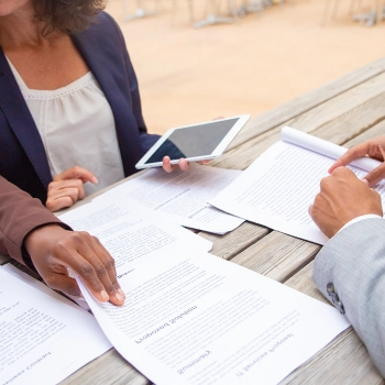 Alabama LLC Operating agreement document being passed on to a businessman