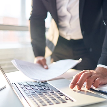 Typing federal income tax document on laptop