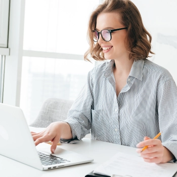 Woman is smiling while working for Missouri LLC taxes