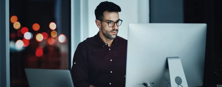 A man working on his computer with the help of AI