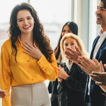 An employee receiving a recognition award