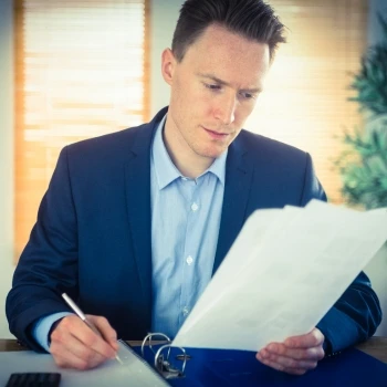 A man in his office working on important documents