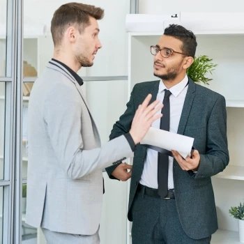 Two individuals having a discussion in an office