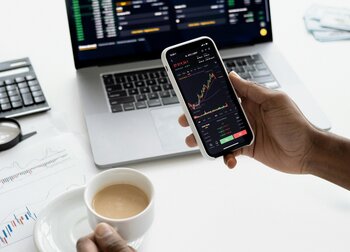 Person trading stocks on smartphone