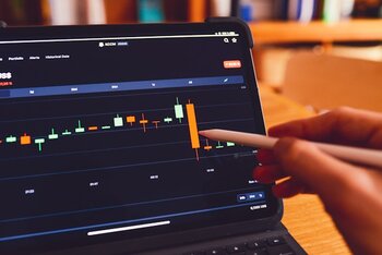 a_person_using_a_laptop_computer_with_a_chart_on_the_screen