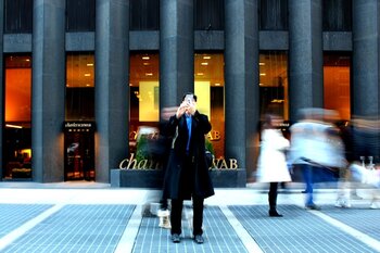 man_standing_in_front_of_charles_schwab_building