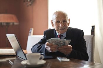 old_man_holding_money_in_his_hands