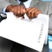 A man tearing a paper after the dissolve of an LLC in Tennessee