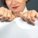 A woman tearing a paper after the dissolve of an LLC in Wisconsin