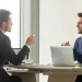 Two professionals having a conversation in an office about Oklahoma's best LLC services