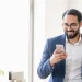 An image of a business man searching how to look up an LLC in Vermont using a smartphone