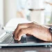 An image of a person using a laptop and doing a search about how to look up an LLC in Wyoming