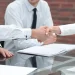 Business person shaking hands with each other to create an LLC in Alabama