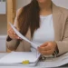 An office worker handling paperwork and reading about how long does it take to form an llc in georgia