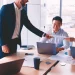 A group of employees discussing around a table on how to change an LLC name in Virginia