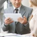 A group of employees arranging the documents after an LLC was dissolved in Wyoming