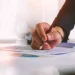 Two Utah registered agents working on paperwork on an office table