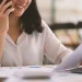 A registered agent in South Dakota looking at paper while on the phone