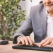 A Wisconsin registered agent man typing on a computer keyboard